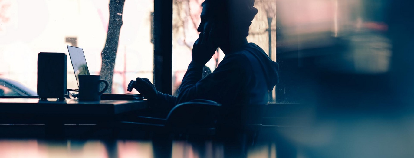 man working on laptop in the bar