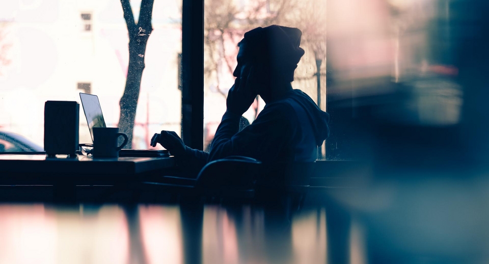 man working on laptop in the bar