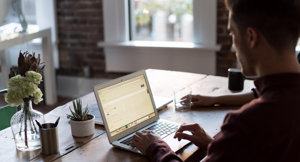 Man coding at a laptop
